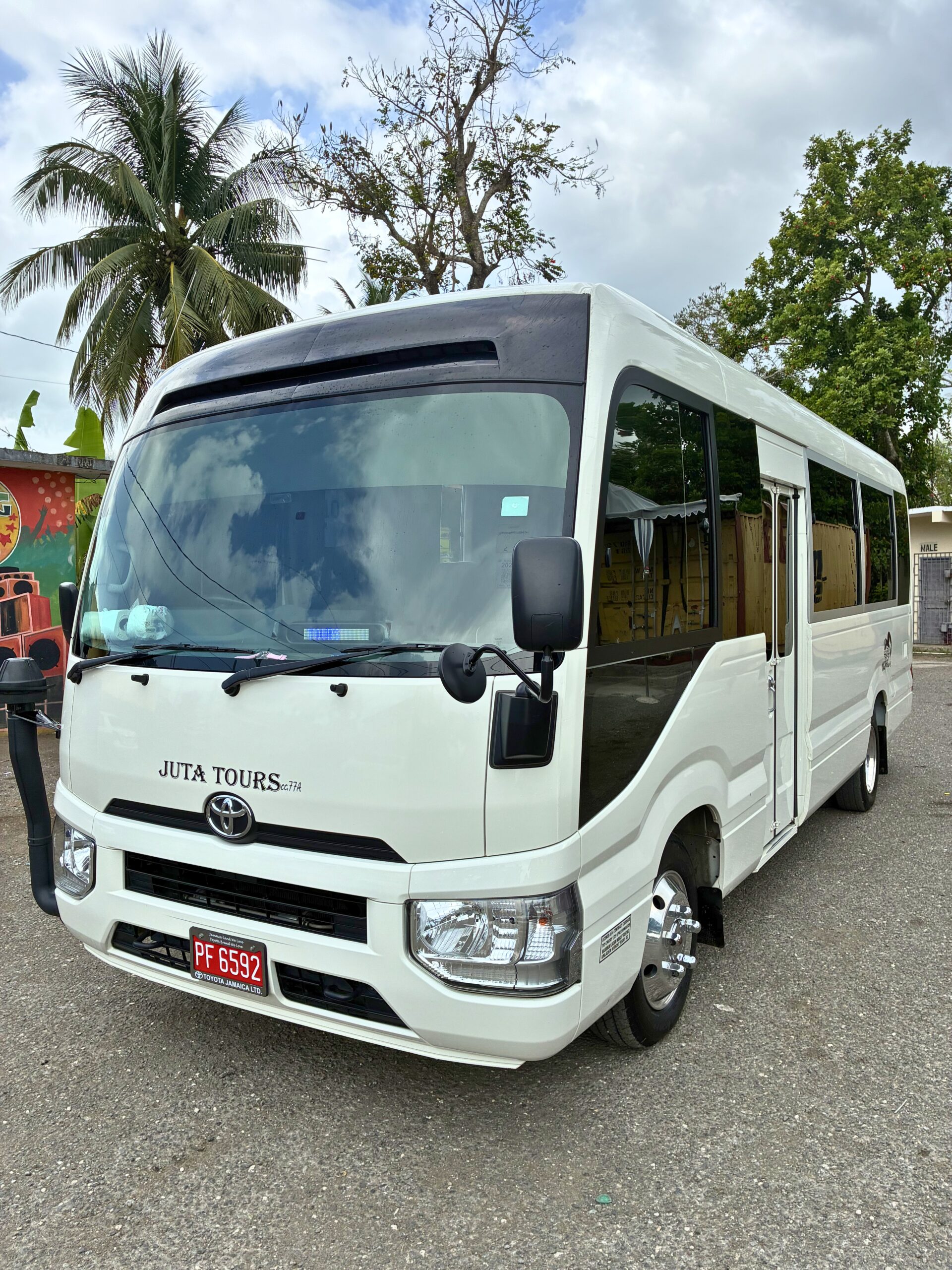 Front exterior of MCR Tours Private Charter Toyota Coaster