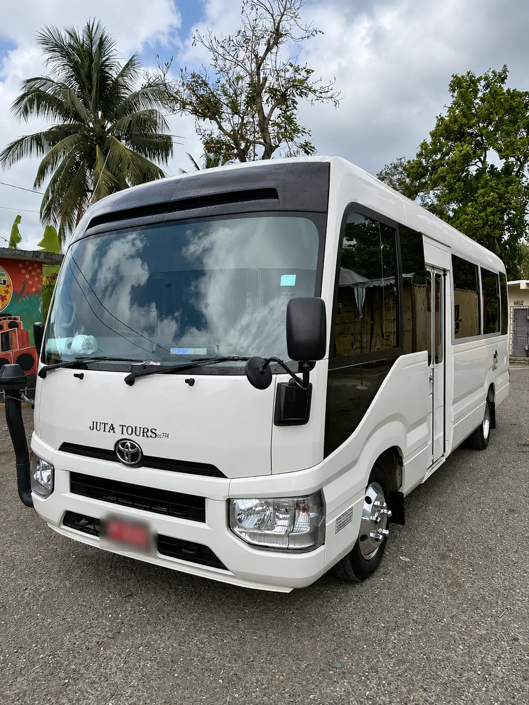 Front exterior of MCR Tours Private Charter Toyota Coaster